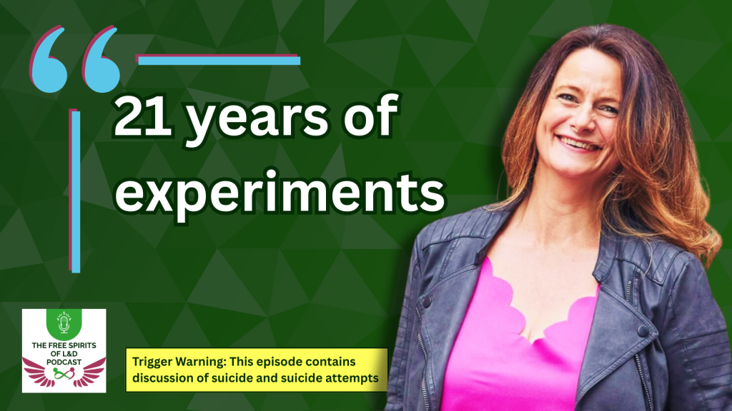 Podcast episode promotional graphic featuring Jules Wyman smiling and standing against a dark green geometric background. Large white text reads “21 years of experiments” with quotation marks in blue and pink. Jules is wearing a pink top and dark jacket. The Free Spirits of L&D Podcast logo appears in the bottom left corner. A yellow trigger warning banner at the bottom reads: “Trigger Warning: This episode contains discussion of suicide and suicide attempts.”