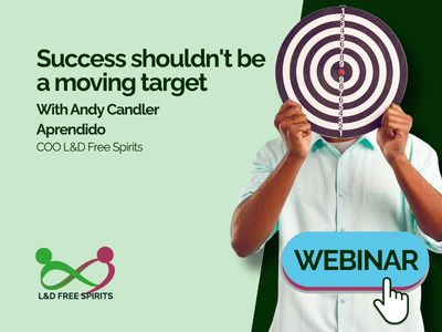 Webinar graphic with the headline “Success shouldn't be a moving target”. A man in a pale blue shirt holds a circular bullseye target in front of his face. Text introduces Andy Candler from Aprendido, COO of L&D Free Spirits. A turquoise “WEBINAR” button with a clicking hand icon appears at the bottom right, with the L&D Free Spirits logo at the bottom left.